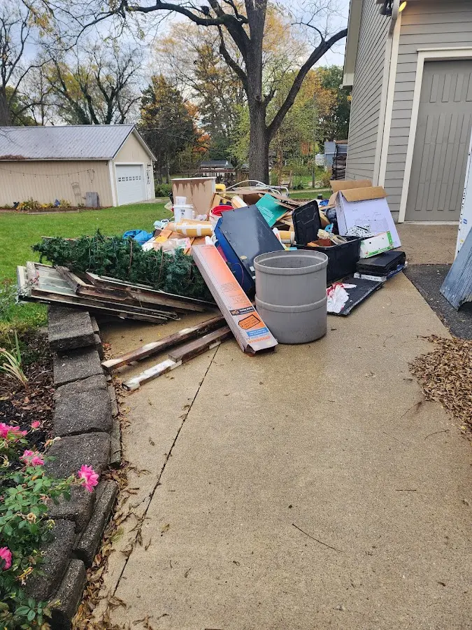 Dumpster being loaded with debris for Roofing Dumpster Rental in North Braddock